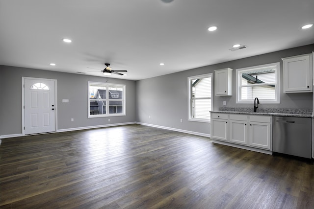 unfurnished living room with a sink, visible vents, dark wood-type flooring, and recessed lighting