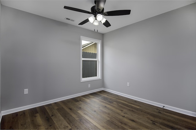 empty room with visible vents, baseboards, dark wood-type flooring, and a ceiling fan