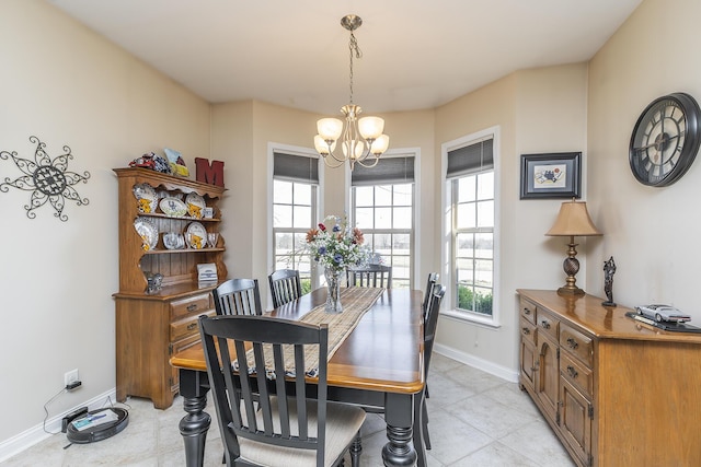 dining area with an inviting chandelier and baseboards