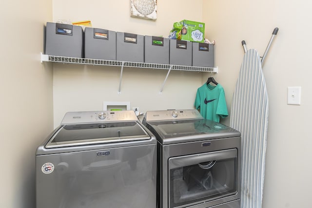 laundry area with laundry area and washer and clothes dryer