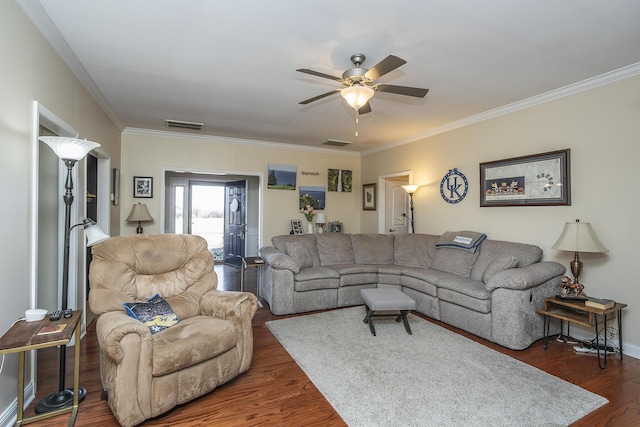 living room with visible vents, ornamental molding, ceiling fan, and wood finished floors