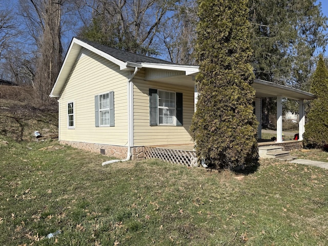 view of home's exterior featuring a lawn and crawl space