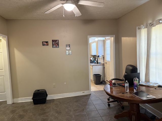 office area with a sink, a textured ceiling, ceiling fan, and tile patterned flooring