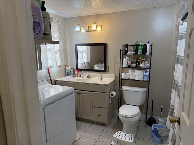 bathroom with vanity, washer / clothes dryer, tile patterned flooring, a textured ceiling, and toilet