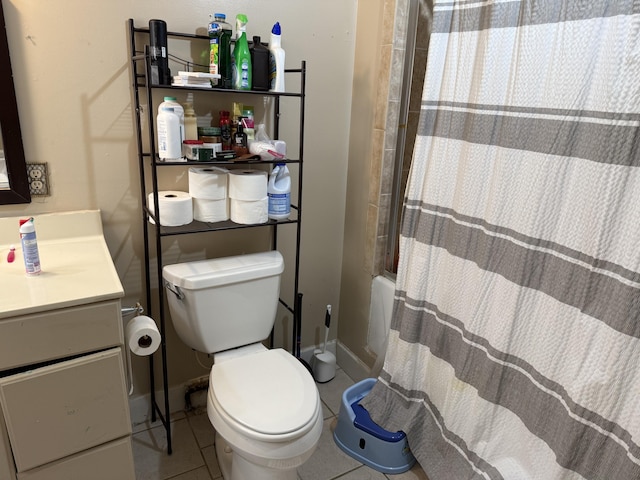 bathroom featuring tile patterned flooring, toilet, vanity, and baseboards