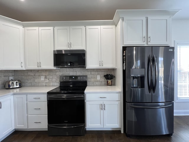 kitchen featuring a wealth of natural light, white cabinets, and stainless steel appliances