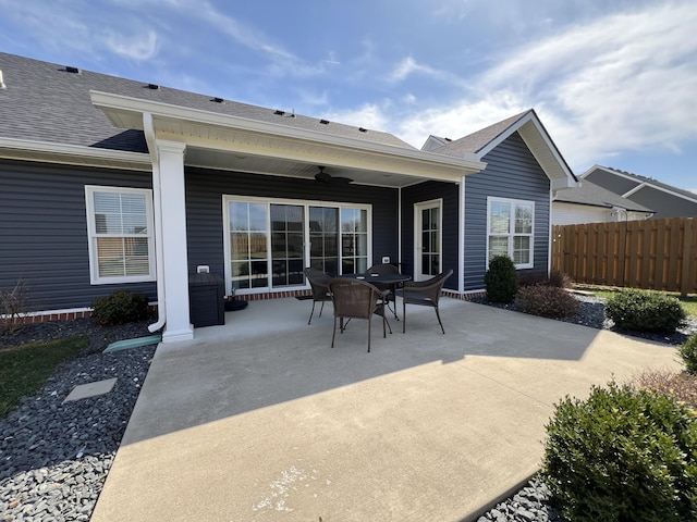 rear view of property featuring a ceiling fan, a patio area, fence, and roof with shingles