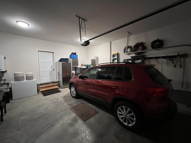 garage featuring water heater and a garage door opener