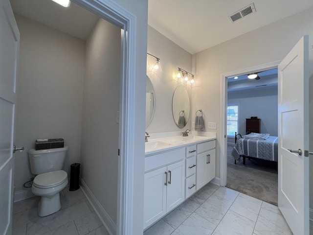 bathroom with a sink, visible vents, toilet, and marble finish floor