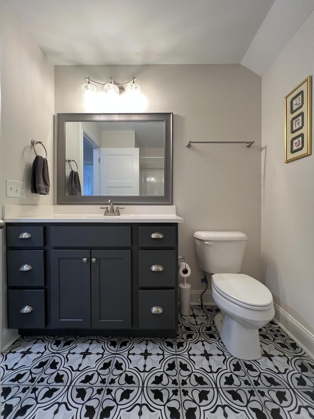 bathroom featuring tile patterned floors, toilet, vanity, and baseboards