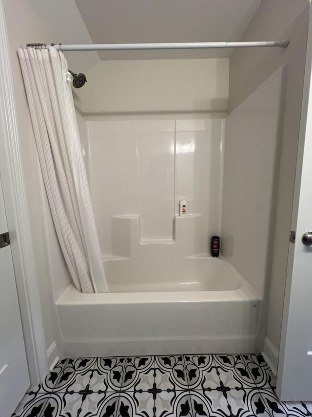 bathroom with tile patterned floors and shower / tub combo