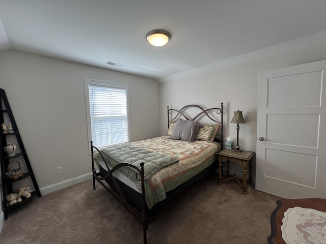 carpeted bedroom featuring vaulted ceiling, baseboards, and visible vents