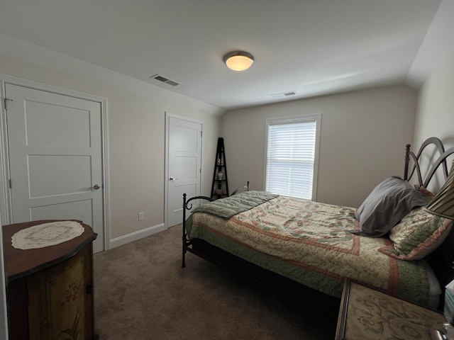 bedroom featuring visible vents, baseboards, lofted ceiling, and carpet floors