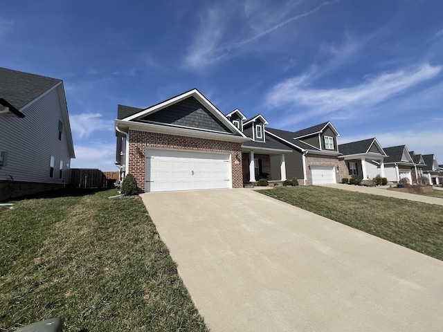 view of front of home with concrete driveway, fence, brick siding, and a front lawn