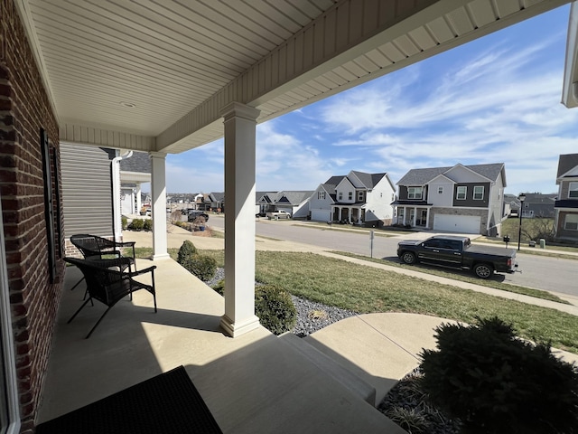 view of patio / terrace with a residential view and covered porch