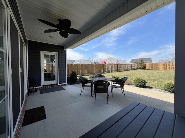 view of patio / terrace with a fenced backyard, outdoor dining area, and a ceiling fan