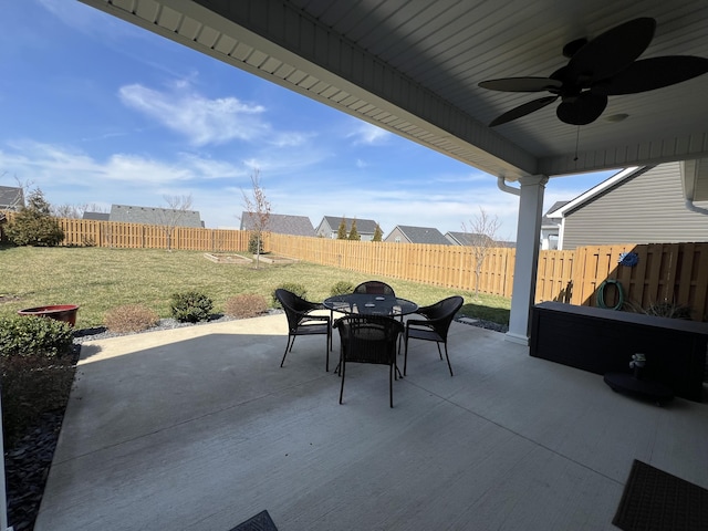 view of patio with a fenced backyard, outdoor dining space, and a ceiling fan