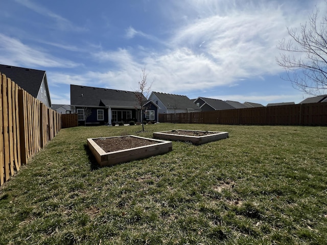 view of yard with a garden and a fenced backyard