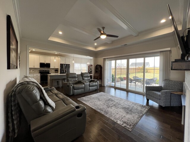 living room with a ceiling fan, dark wood finished floors, recessed lighting, ornamental molding, and a raised ceiling