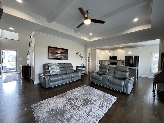 living room featuring dark wood finished floors, crown molding, and baseboards