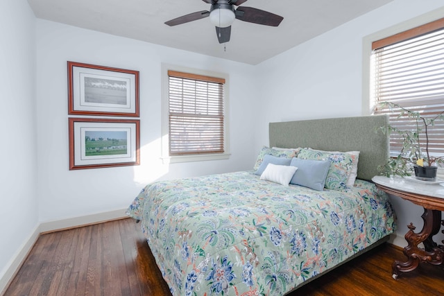 bedroom featuring ceiling fan, baseboards, and hardwood / wood-style floors