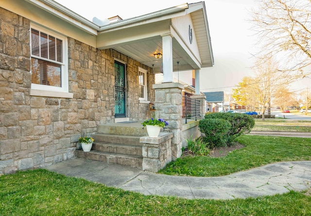 property entrance featuring a porch and stone siding