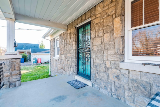 doorway to property featuring stone siding