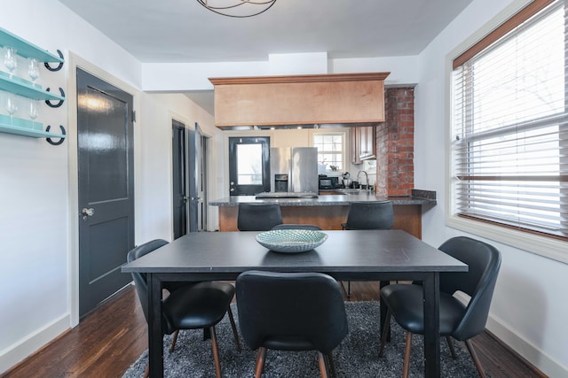 dining room featuring baseboards and dark wood finished floors