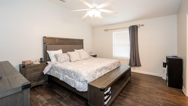 bedroom with dark wood finished floors, vaulted ceiling, baseboards, and ceiling fan