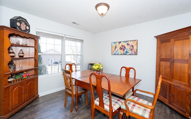 dining space featuring visible vents, baseboards, and dark wood-style flooring