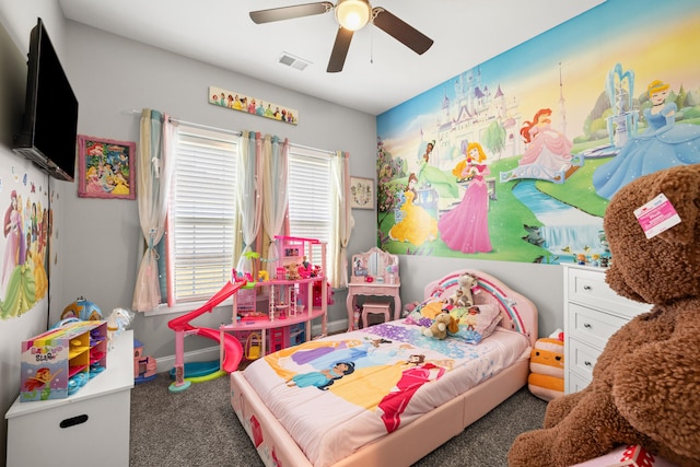 carpeted bedroom with visible vents, baseboards, and a ceiling fan