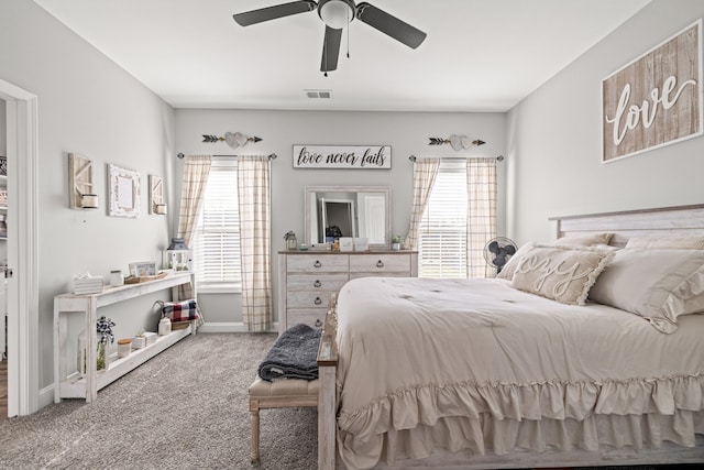 carpeted bedroom with visible vents, multiple windows, and baseboards