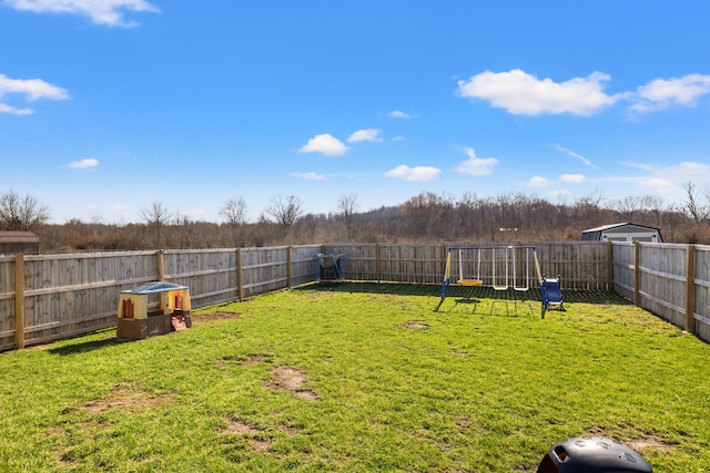 view of yard with a playground and a fenced backyard