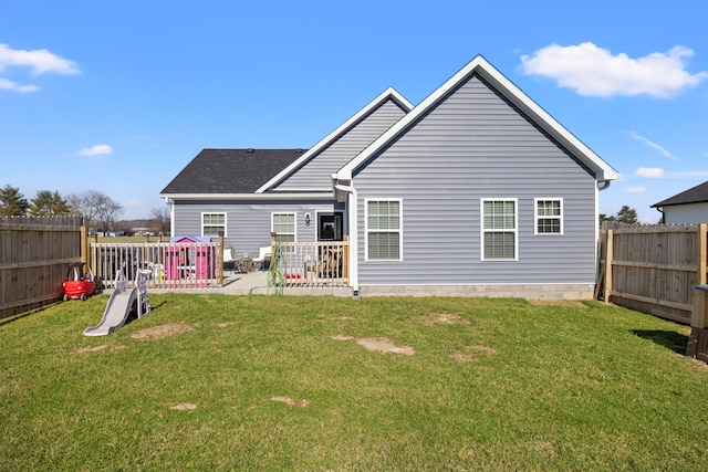 back of house with a yard, a fenced backyard, and a patio area