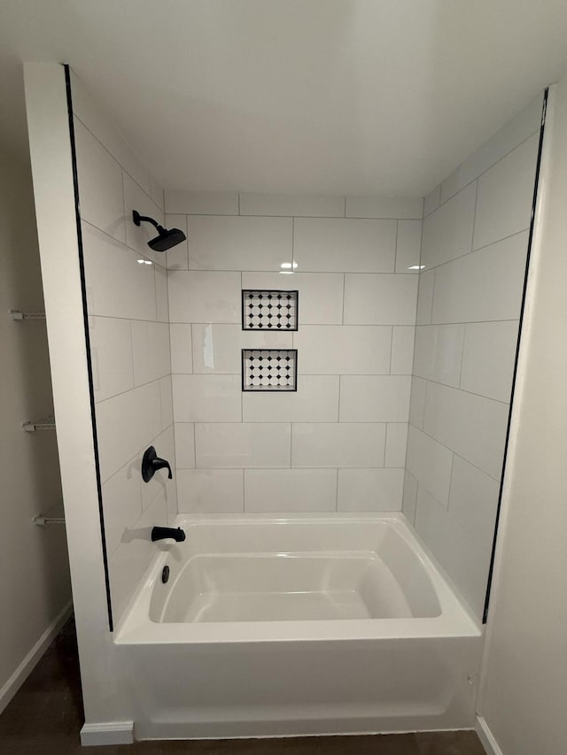 bathroom with baseboards and bathing tub / shower combination