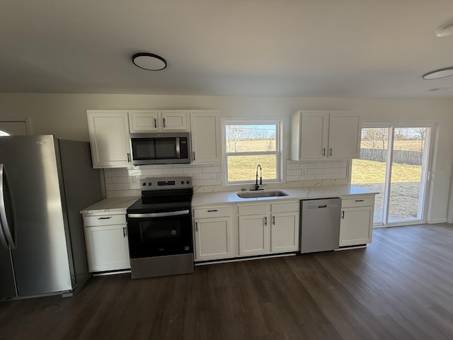 kitchen featuring a sink, appliances with stainless steel finishes, and white cabinetry