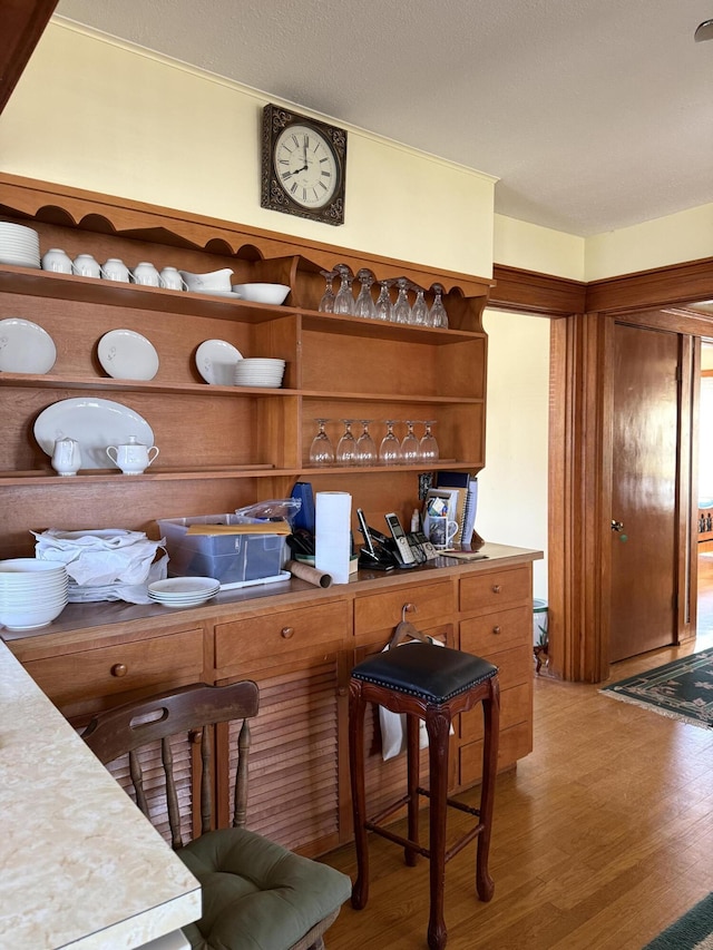 kitchen featuring light wood finished floors and open shelves