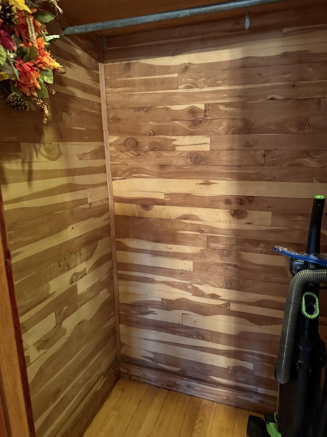 bathroom with wooden walls and wood finished floors