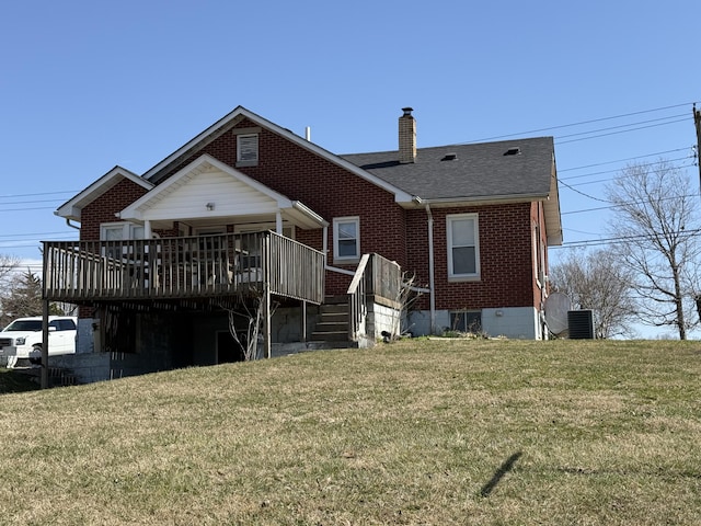 back of house with roof with shingles, a wooden deck, a yard, a chimney, and brick siding