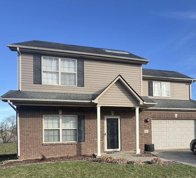 804 Orange Blossom Dr, Nicholasville, KY 40356 - traditional home featuring brick siding, concrete driveway, an attached garage, and a shingled roof
