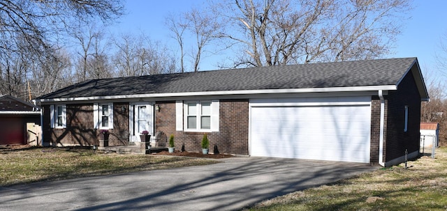 ranch-style house featuring brick siding, an attached garage, and a shingled roof