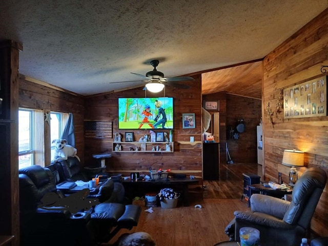 living area with vaulted ceiling, wood finished floors, wood walls, and a textured ceiling