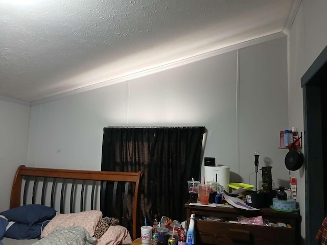 bedroom featuring a textured ceiling and crown molding