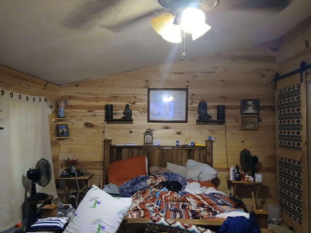 bedroom with wood walls, a ceiling fan, and vaulted ceiling