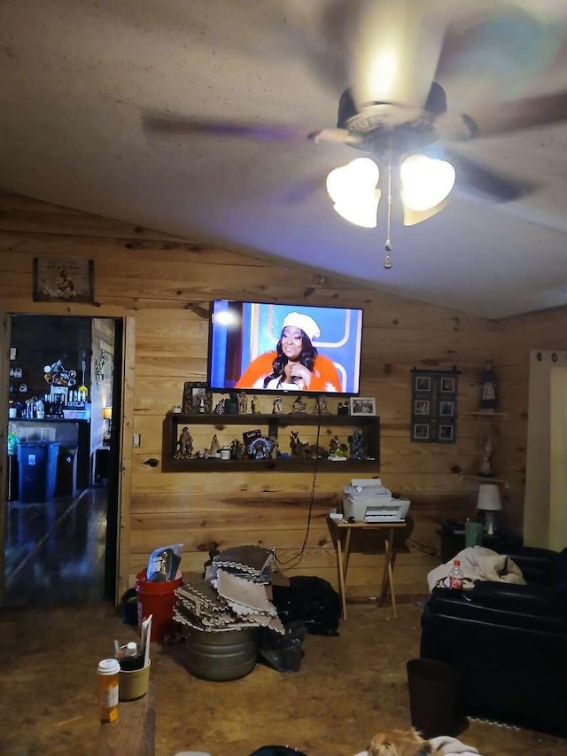 living area with wooden walls, a ceiling fan, and lofted ceiling