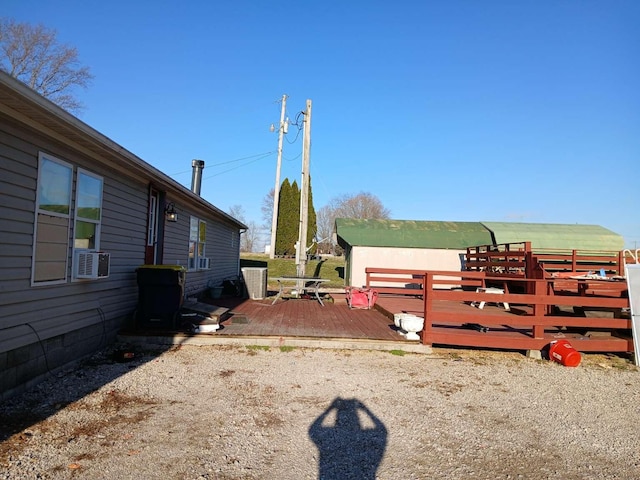 view of yard featuring cooling unit and a wooden deck