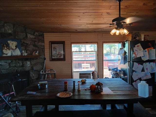 dining space with a fireplace and wood ceiling