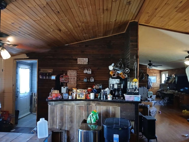 bar featuring wooden walls, wood finished floors, ceiling fan, vaulted ceiling, and wooden ceiling