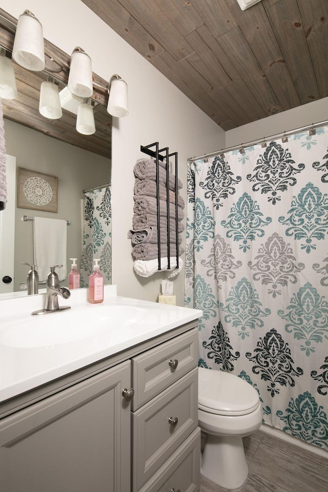 bathroom with toilet, curtained shower, lofted ceiling, wood ceiling, and vanity