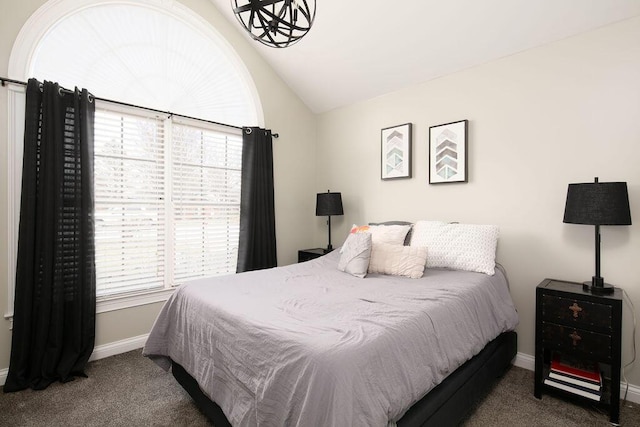 bedroom with carpet flooring, baseboards, and lofted ceiling